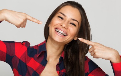 face of a young woman with braces on her teeth picture